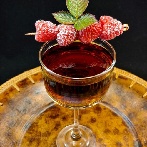 cocktail garnished with raspberries