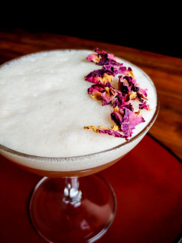 cocktail topped with foam and dried flowers