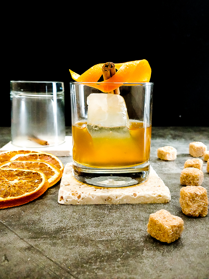 smoked old fashioned with orange peel and sugar cubes