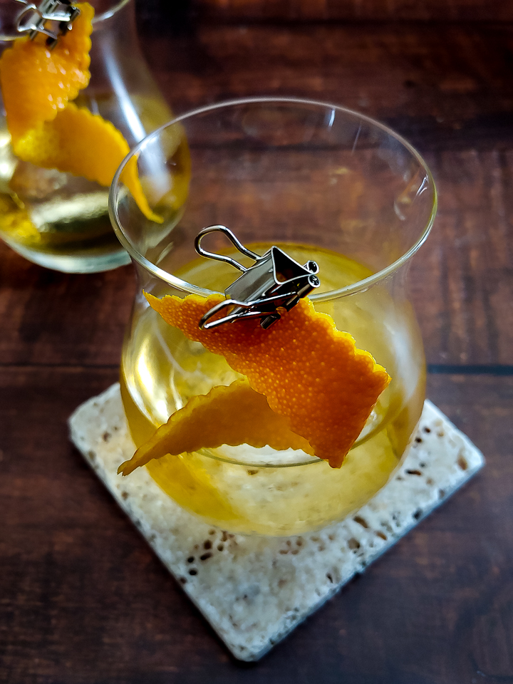 tequila cocktail with orange garnish