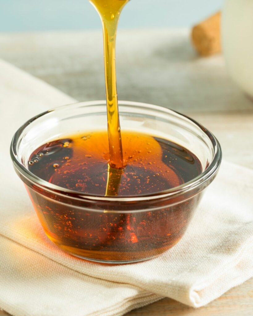 small bowl of syrup with a drizzle poured into it.