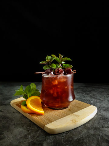 Cherry cocktail with cherry and mint garnish