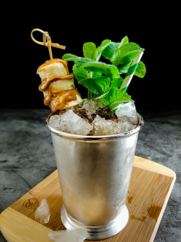 cocktail in julep cup with banana peanut butter garnish
