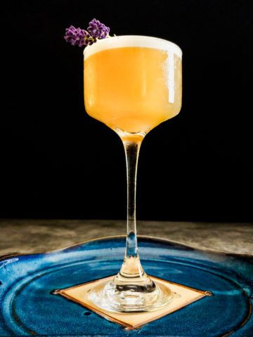 foam topped whiskey sour with lavender sprig