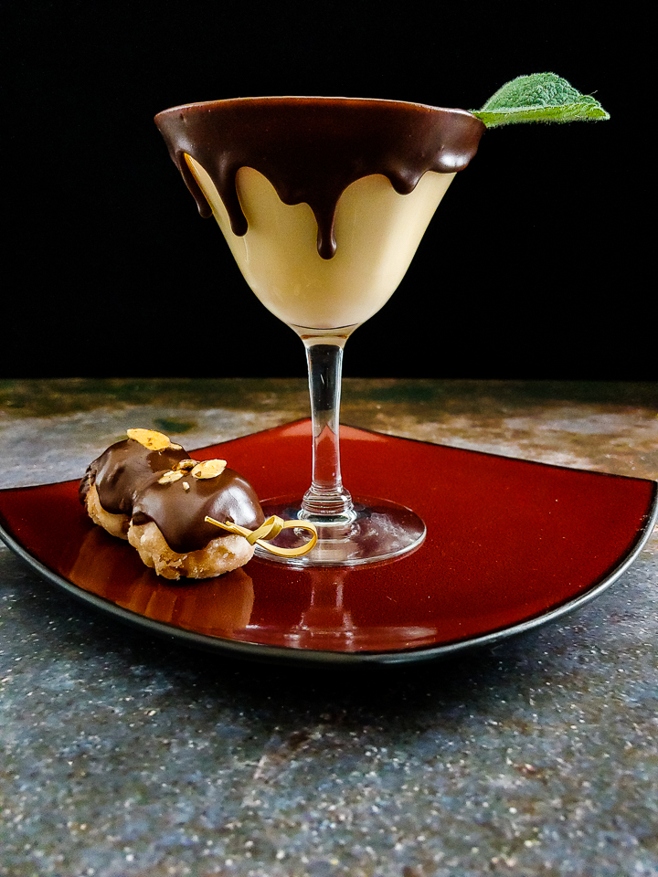 cream cocktail in chocolate dipped glass with donut holes