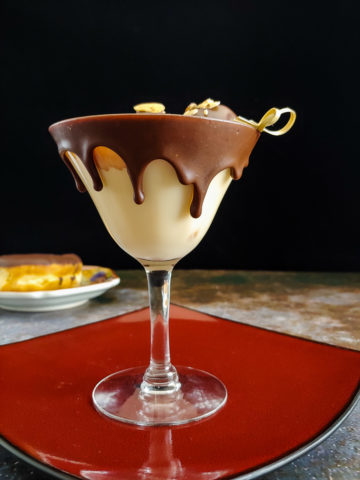 cream cocktail in chocolate dipped glass with donut holes
