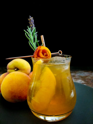 Peach Old Fashioned with peach rose and lavender sprig