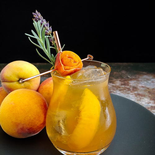 Peach Old Fashioned with peach rose and lavender sprig