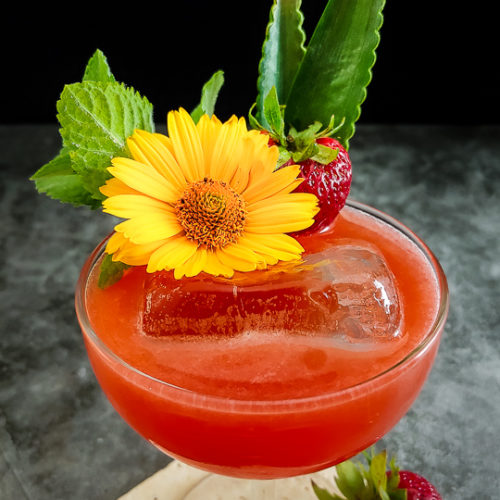 strawberry cocktail with fresh flowers, ming and strawberry garnish