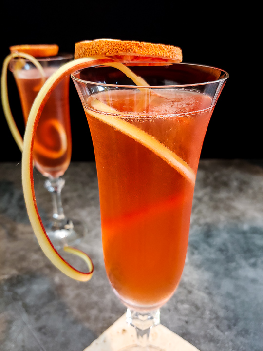 Aperol spritz cocktail with dried blood orange and rhubarb curl