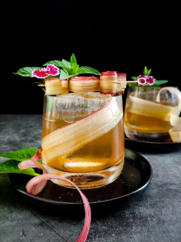 old fashioned cocktail with rhubarb roses, flowers and mint