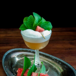 whiskey sour with watermelon and mint garnish