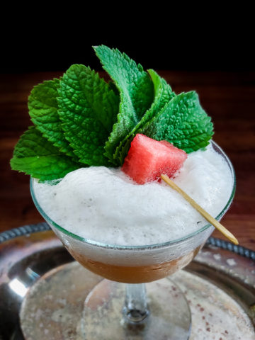 whiskey sour with watermelon and mint garnish