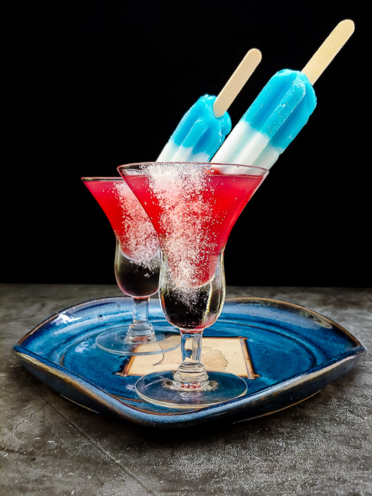 red bourbon margarita topped with a bomb pop