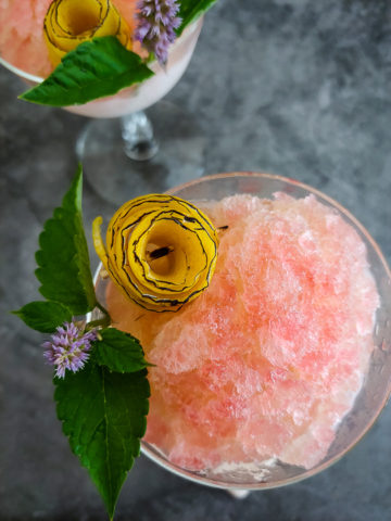 frozen sazerac garnished with lemon rose and mint