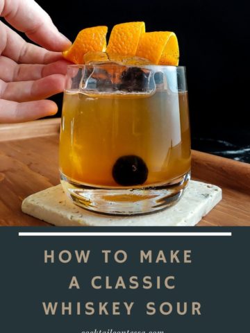 placing orange garnish on a classic whiskey sour
