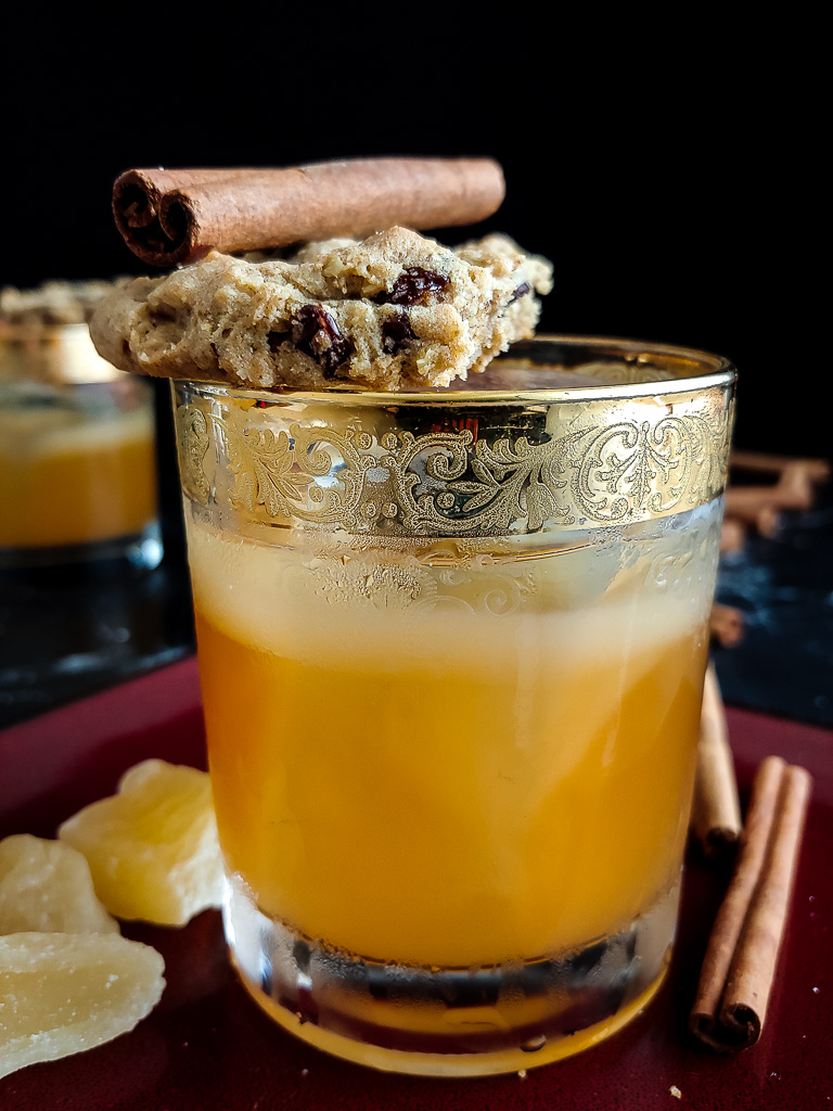 oatmeal cookie old fashioned with cookie and cinnamon stick garnish