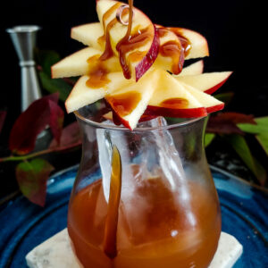 Caramel Apple Old Fashioned cocktail with apple fan and caramel drizzle