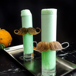 Halloween Ramos Fizz, green with moustaches on the glasses
