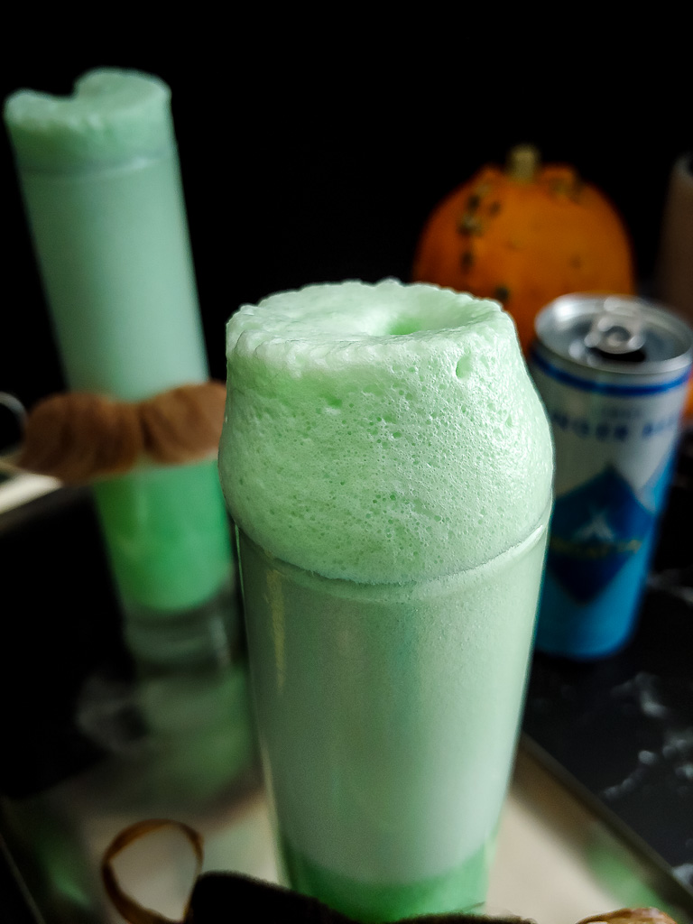 Halloween Ramos Fizz, green with moustaches on the glasses