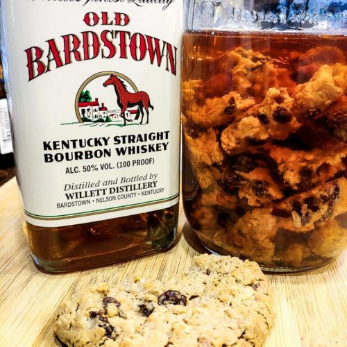 Bottle of bourbon, oatmeal cookie and oatmeal cookie-infused bourbon