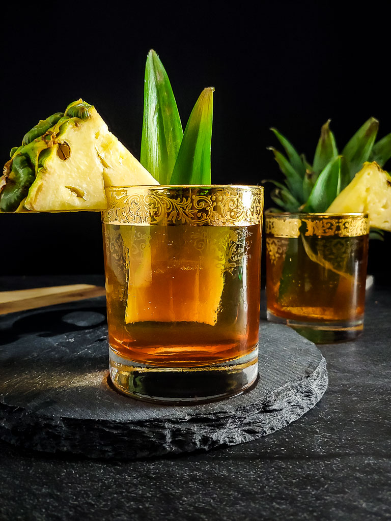 Rum tiki old fashioned with pineapple garnish