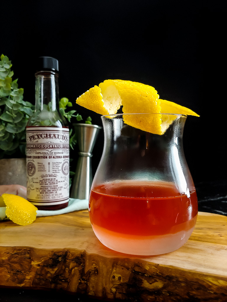 Sazerac cocktail with lemon garnish and Peychaud's bitters
