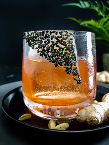 Fernet Sazerac cocktail garnished with sesame seed and ginger powder rim in rocks glass