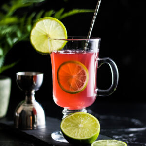 Gin Toddy - view of pink toddy with lime garnish