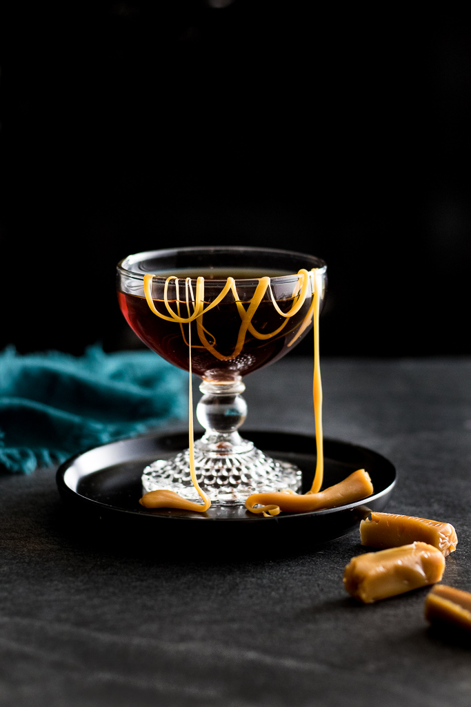 Salted Caramel Manhattan cocktail in a coupe glass with a drizzle of sea salt caramels in it