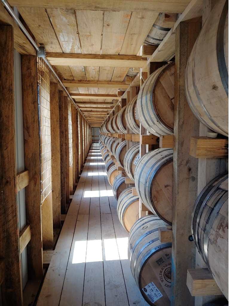 Wilderness Trail Bourbon Rickhouse, sun through windows into the sides of barrels resting in ricks