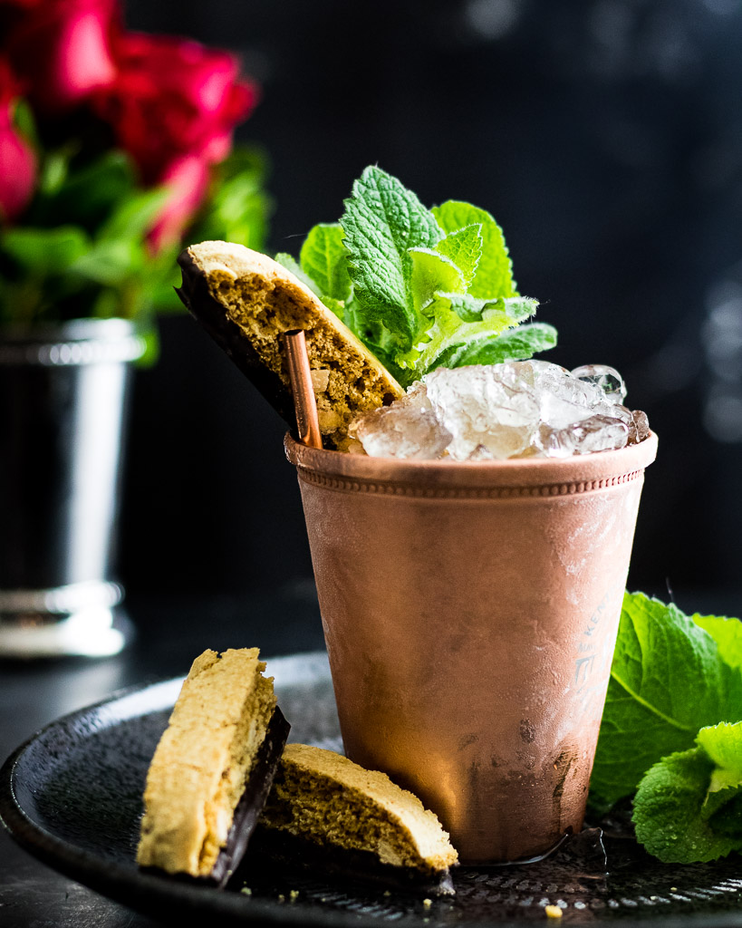 Amaretto Julep in a copper cup with mint and biscotti garnish