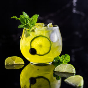Suze cocktail - yellow mule with lime wedges and mint