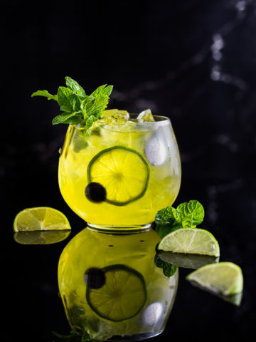 Suze cocktail - yellow mule with lime wedges and mint