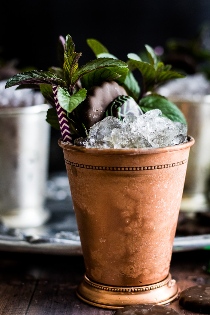 Chocolate mint julep in a copper mint julep cup garnished with mint, thin mint cookie and chocolate mint candy