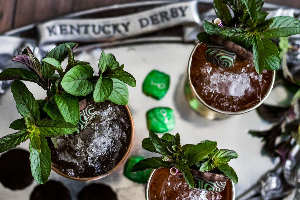 Chocolate mint julep in a copper mint julep cup garnished with mint, thin mint cookie and chocolate mint candy