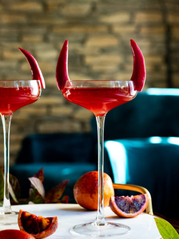 Bloody Boulevardier Halloween Drink in two coupes with mint and pepper garnish