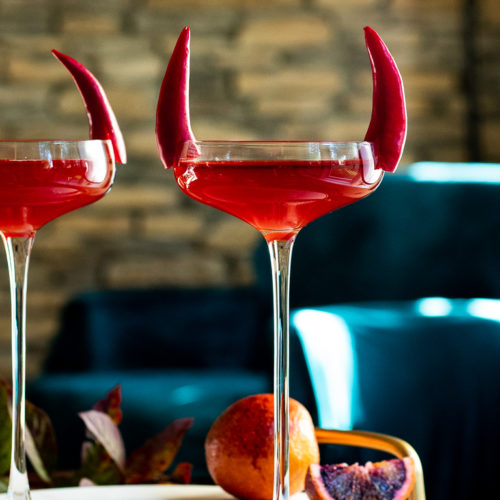 Bloody Boulevardier Halloween Drink in two coupes with mint and pepper garnish