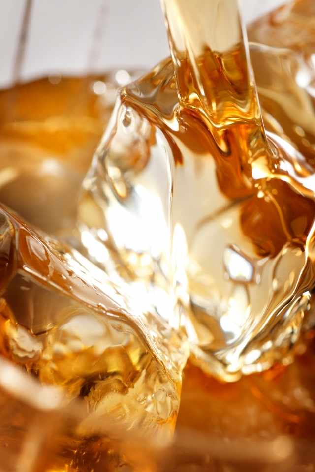 close up of a pour of whiskey into a glass