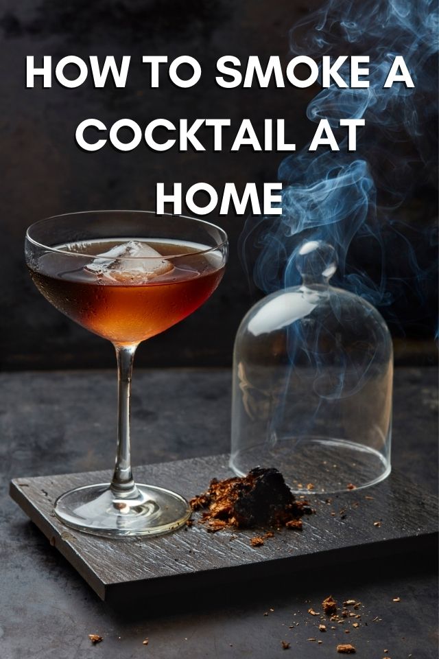 Making a smoky drink with a cocktail smoker.