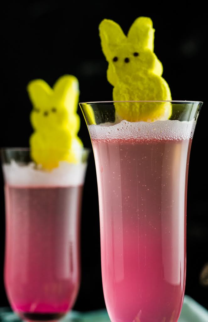 Peeps Cocktail - an Easter Mimosa: two pink cocktails in champagne flutes with Peeps as garnishes